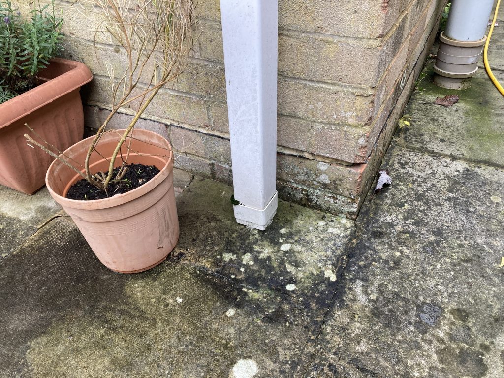 A home in Melksham where the downpipe enters the soakaway without protection.